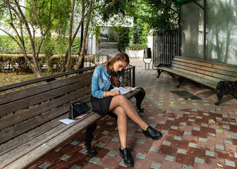 person sitting on bench in park