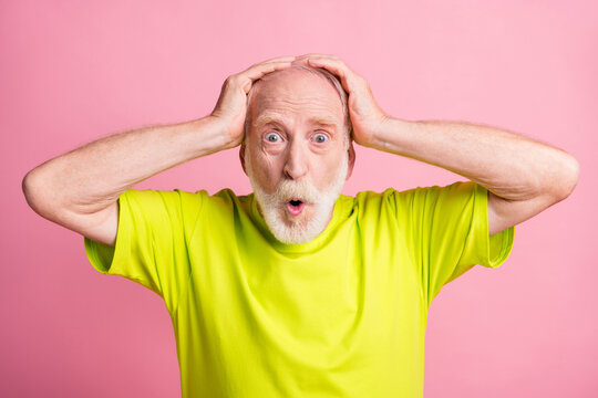 Portrait of shocked person put hands on head open mouth staring wear lime isolated on pink color background