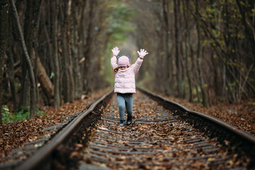 girl in railway green tunnel. love tunnel in autumn. Railway and tunnel from trees..
