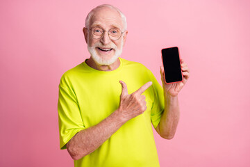 Photo of old happy cheerful smiling grandfather wear lime t-shirt point finger at cellphone...
