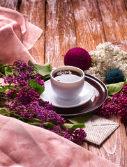 Coffee Cup And Colorful Lilac Flowers On Garden wooden Table