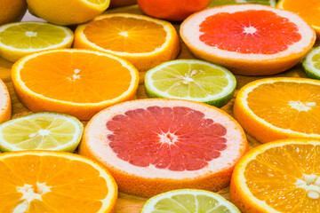 Citrus fruit background with sliced f oranges lemons lime tangerines and grapefruit