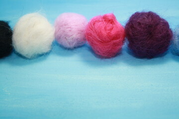 Balls of colored wool for making beads.