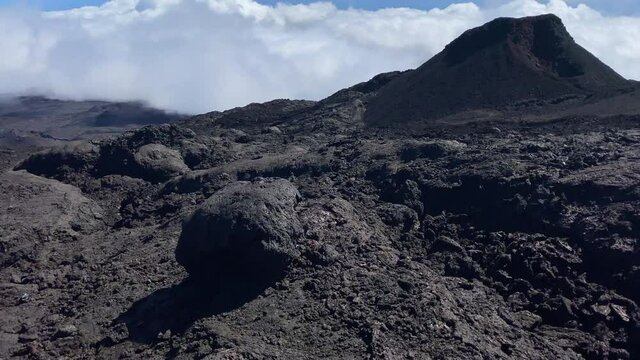 View of the volcanic landscape of Piton de la Fournaise volcano above the clouds on Reunion Island