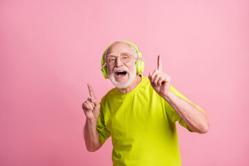 Photo of singing funny old man listen music dance wear headphones spectacles lime color clothes...