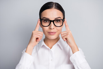 Photo of lovely successful girl fingers hold eyewear look camera wear white shirt isolated grey color background