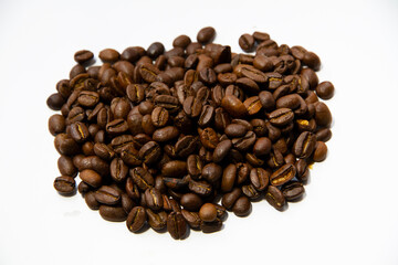 Roasted coffee beans heap isolated on white background