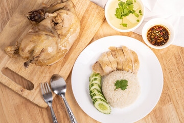 Chicken rice on the wooden table in a Thai restaurant.