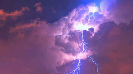 Lightning strikes between stormy clouds.