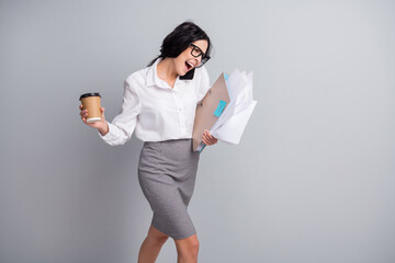 Fototapeta premium Photo of stressed busy girl speak phone hold cup folder wear specs white shirt mini skirt isolated grey color background