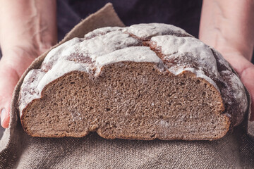 The cook holds fresh round bread