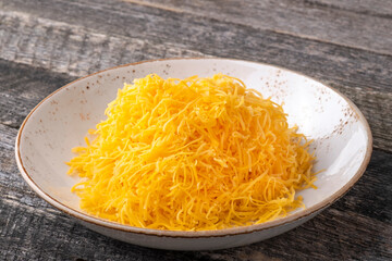 Grated yellow cheese on a plate