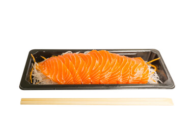 Salmon Sashimi on vegetable slices in black tray, a bamboo chopsticks on side