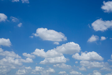 Beautiful white fluffy clouds on vivid blue sky in a suny day