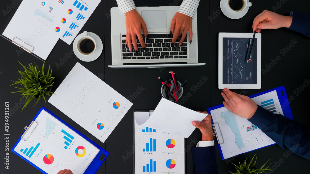 Poster high angle view of business team working with financial reports at corporate office table analysing 