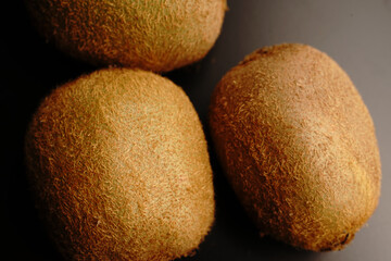 Kiwi fruit on a dark background. Close.