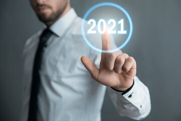 man touching 2021 in screen