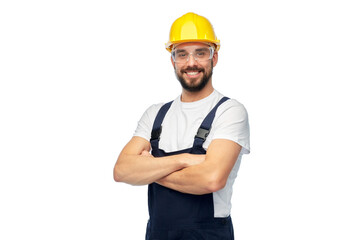 profession, construction and building - male worker or builder in yellow helmet and goggles with crossed arms over white background - obrazy, fototapety, plakaty