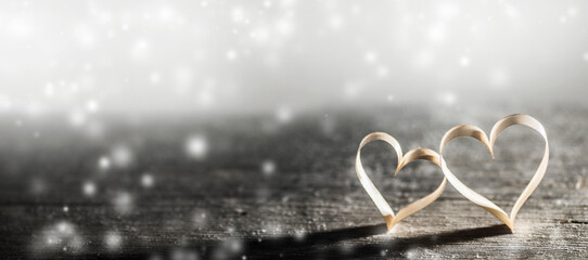 Golden ribbon hearts on wood