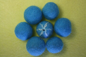Woolen beads on a yellow background