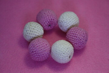 Beads on a pink background.