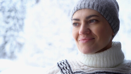 Portrait of beautiful smiling brunette woman wearing knitted nordic print sweater in winter scenery 