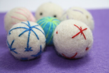 Woolen beads on a violet background.