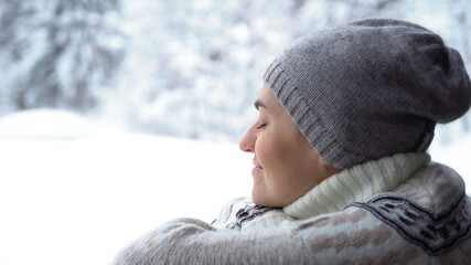 Portrait of happy woman relaxing in winter forest