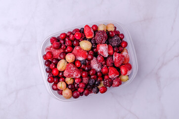 Frozen berry mix in a plastic container