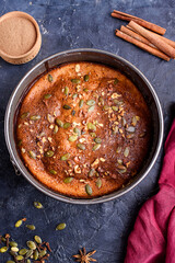 Pumpkin pie with lemon zest, pumpkin seeds, cinnamon, fragrant spices and spices on a dark background. Healthyfood