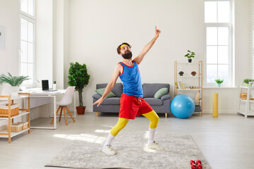 Funny man doing fitness exercise, dancing and fooling around during workout at home