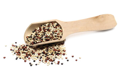 Tri-color quinoa seeds blend pile with wooden spoon isolated on white background