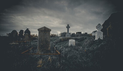 Ireland celtic cross at medieval church cemetery Old spooky cemetery . Haunted cemetery. Scary...