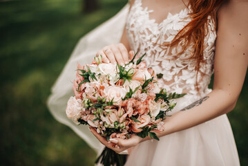 Bridal bouquet with pink flowers on lace background