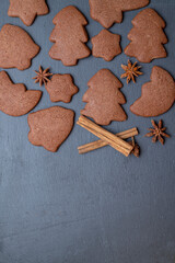 Christmas gingerbread and cinnamon on ardesia place for text at the bottom, vertical position