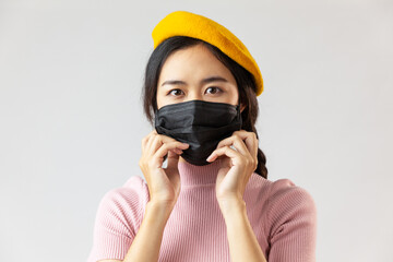young asian woman wearing a mask from her face using a protective mask that had trouble breathing during the COVID-19 epidemic, coronavirus, pm 2.5 air pollution.