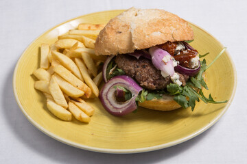Beef burger with fries.