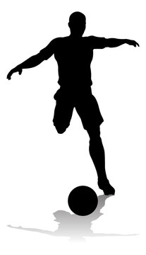 A soccer or football player in silhouette