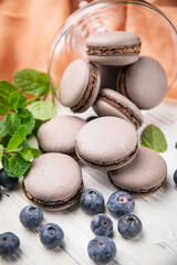 Macaroon with berries on a wooden table
