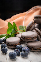 Macaroon with berries on a wooden table
