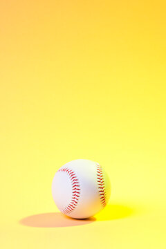 Baseball ball on yellow background. Team sport concept
