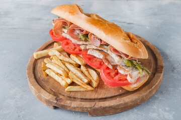 Sandwich Serranito typical in Andalusia with ham, gren pepper and grilled pork loin