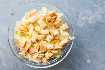 Caesar salad with toast, lettuce and grilled chicken breast