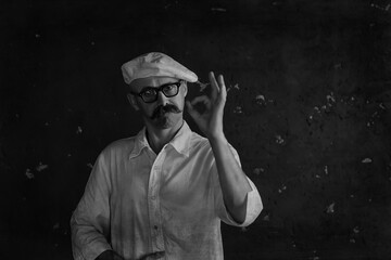 portrait of a cook, mustachioed male chef in a hat, profession