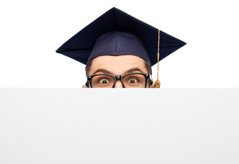 education, graduation and people concept - male graduate student or bachelor in mortarboard and glasses hiding behind white board