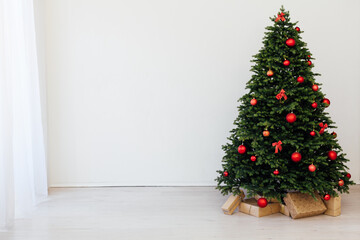 Beautiful holdiay decorated room with Christmas tree with presents under it