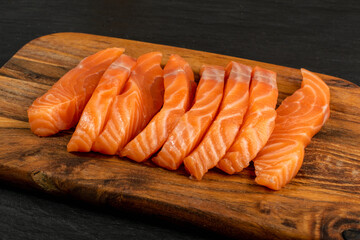 Slices of Raw Salmon Fillet on Black Background Mockup Top View