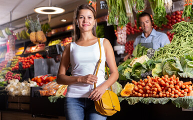 Portrait of cheerful female customer and friendly shop assistant in vegetable shop