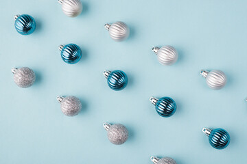 Close up photo of small little toy tree balls lying in straight line isolated pastel color background
