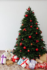 Beautiful holdiay decorated room with Christmas tree with presents under it